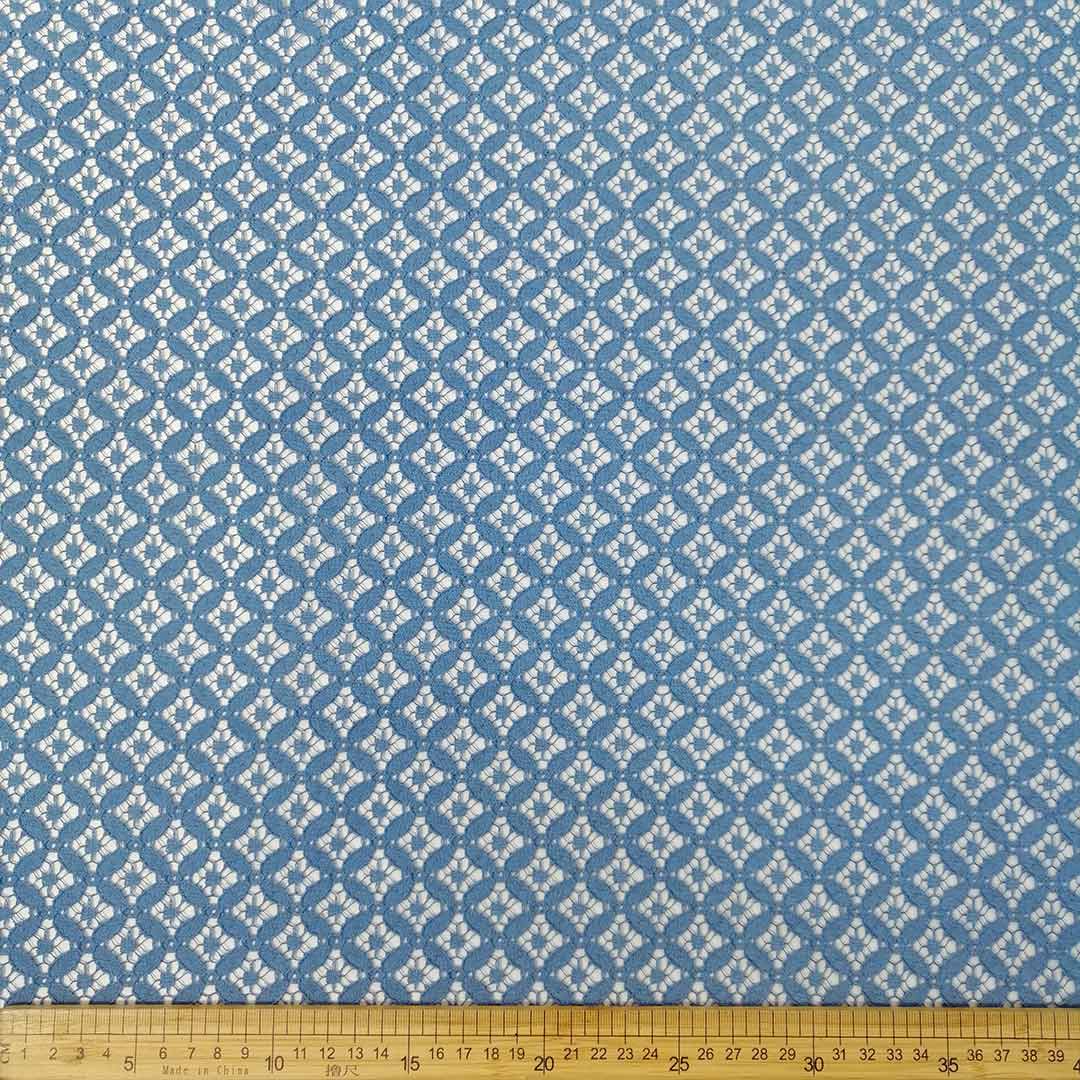 : Cotton Nylon Lace Indigo Diamond 15287/006 fabric with a diamond lace pattern in indigo, ideal for fashion and home decor projects.