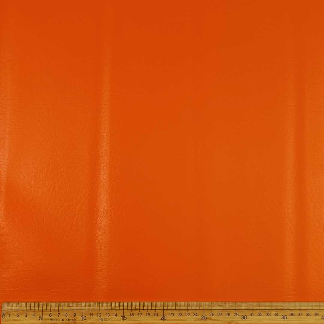 CU130121-11_1.jpg Metro Lifestyle’s Vinyl Plain 140cm Orange – Smooth, durable orange vinyl fabric, perfect for upholstery, car interiors, and DIY décor projects.